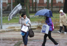 Temporal de viento y lluvia en Palencia. En la imagen unas mujeres sortean el agua y el viento en la plaza de la Pio XII de Palencia. / Brágimo (ICAL)