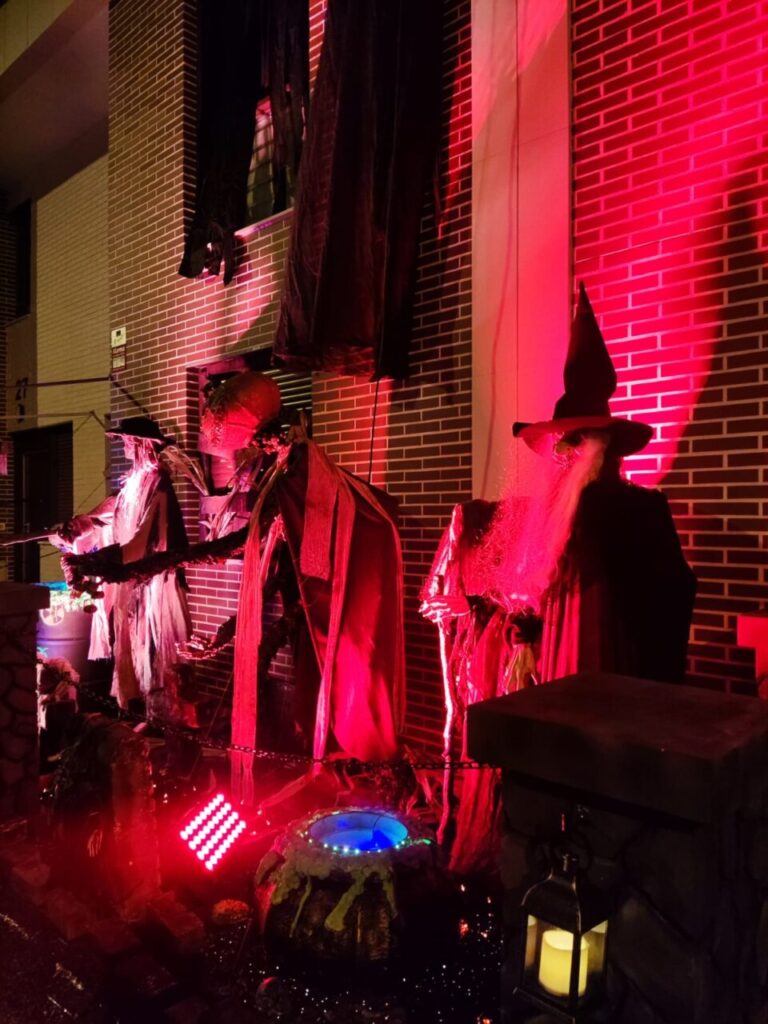 Decoraciones de Halloween con brujas y luces rojas en Palencia