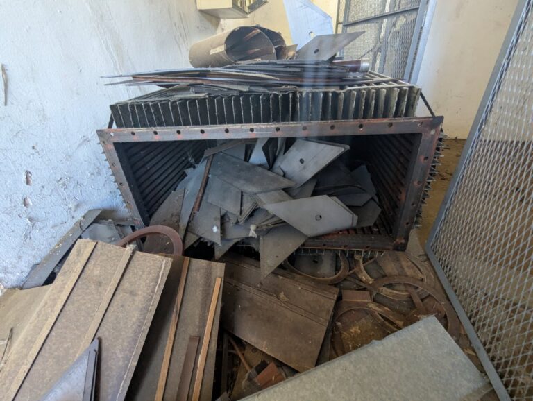 Interior de una quesería abandonada con escombros y chatarra