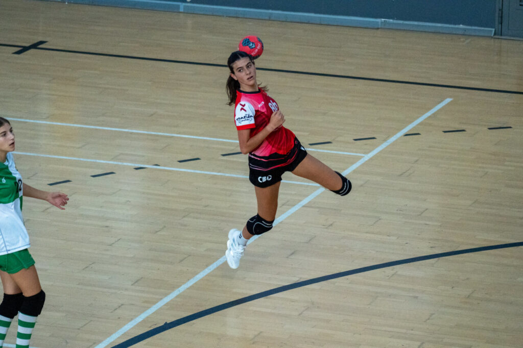 Jugadora de balonmano lanzando el balón en un partido