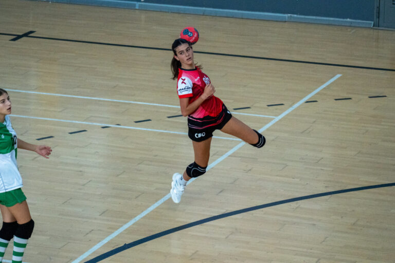 Jugadora de balonmano lanzando el balón en un partido