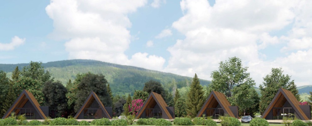 Vista de un camping ecológico en Velilla del Río Carrión con bungalows y naturaleza.