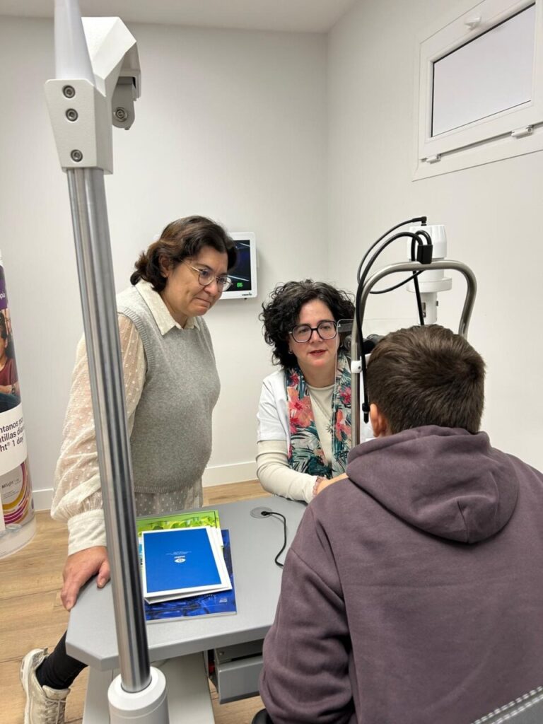 Tres personas en una consulta de control de miopía infantil