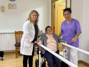 Personal de la Residencia Menéndez Pelayo asistiendo a una residente mayor