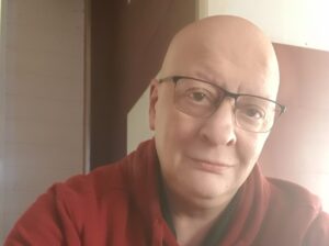 Retrato de un hombre con gafas y sudadera roja