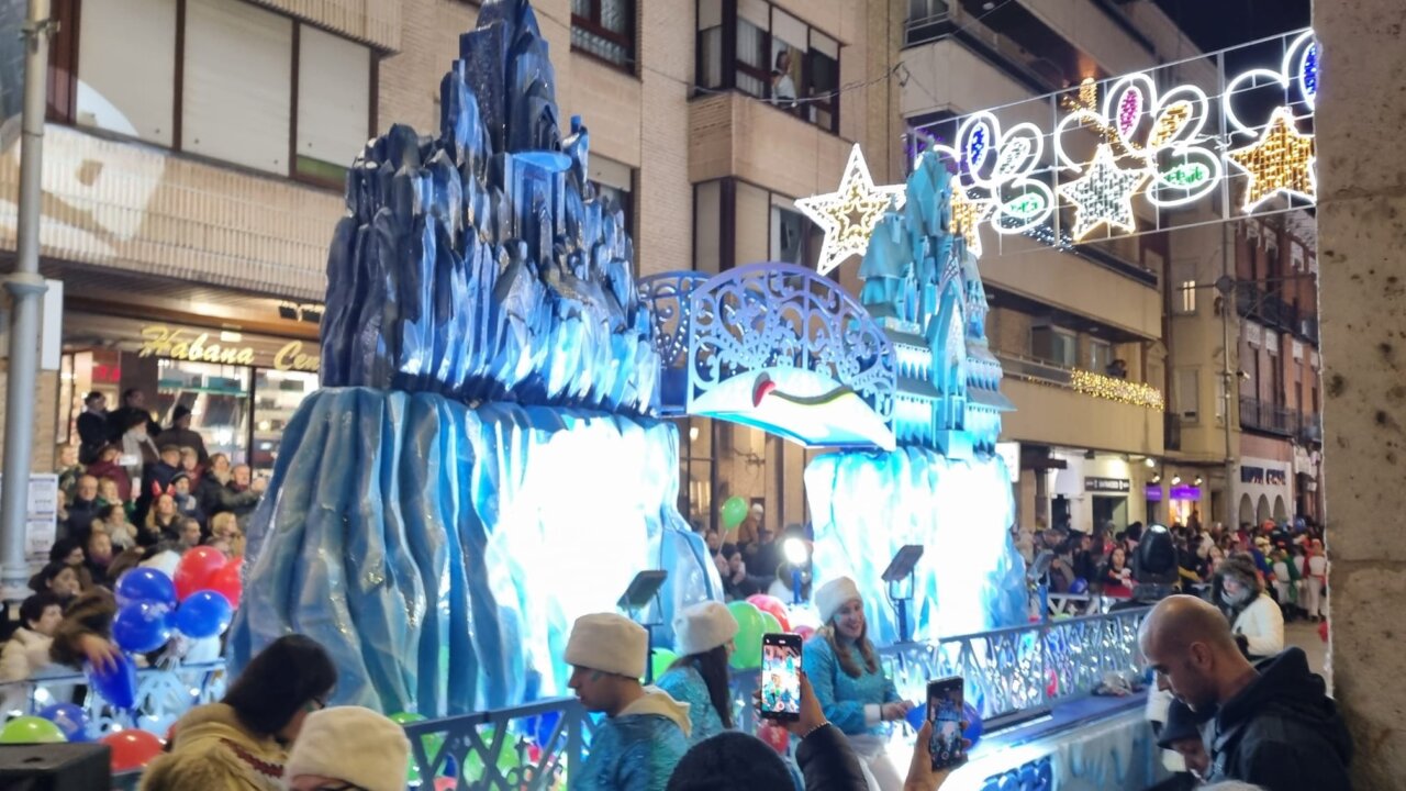 Desfile navideño en Palencia con carroza iluminada y público