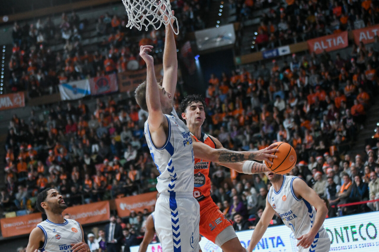 Jugadores de baloncesto en un partido entre Palencia y Coruña