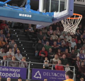 Jugador del Palencia realizando un mate durante un partido de baloncesto