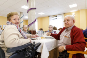 Personas mayores disfrutando de un evento musical en una residencia.