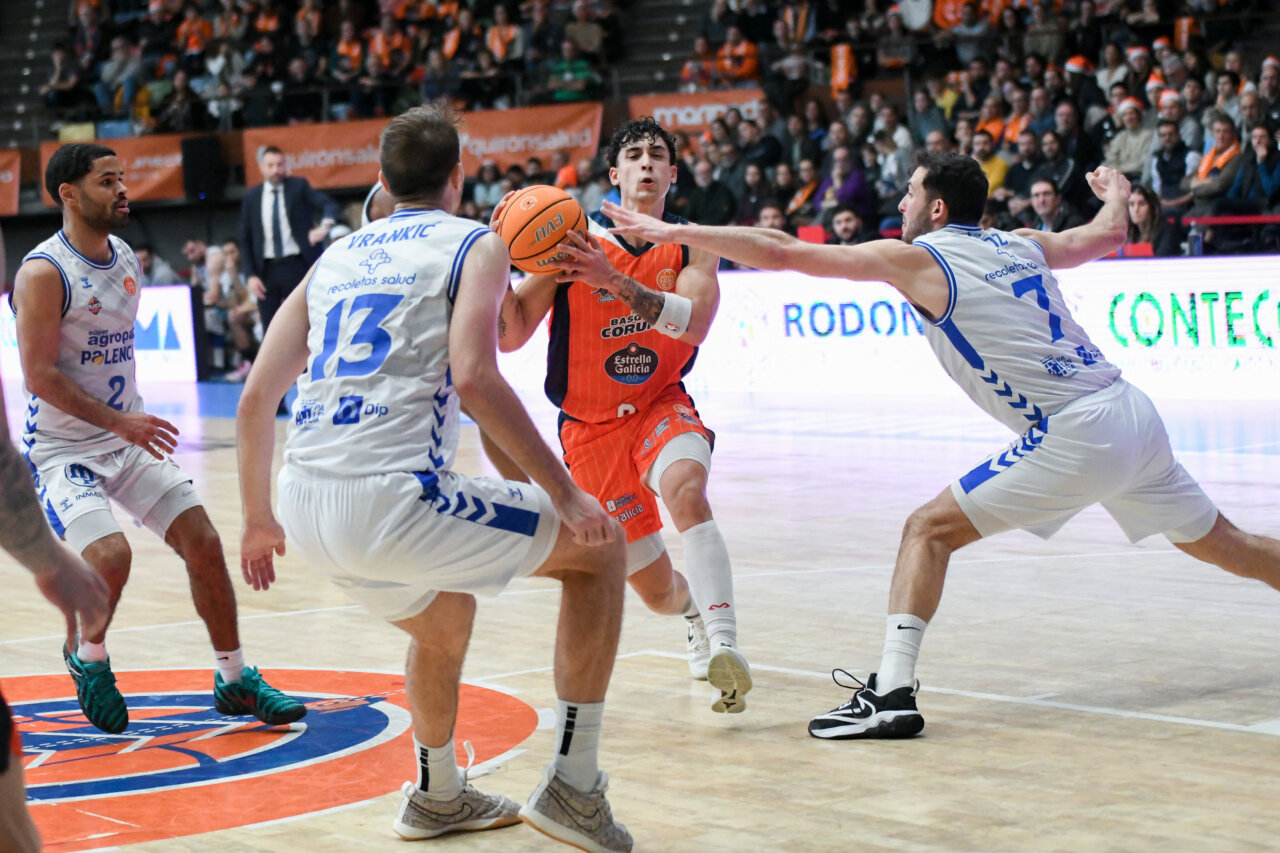 Jugadores de baloncesto en acción durante un partido entre Agropal y Coruña.