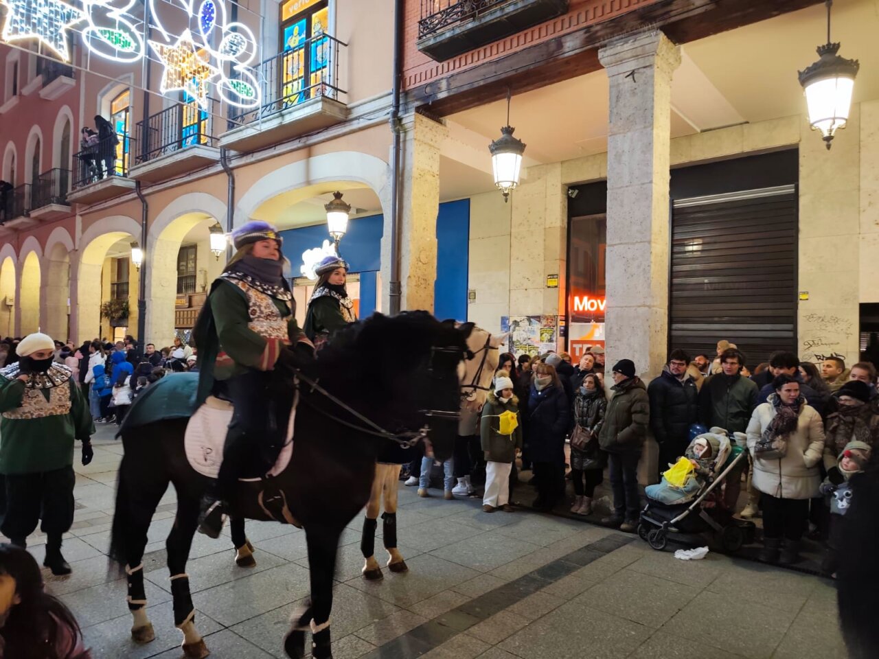 Cabalgata de Reyes en Palencia con participantes a caballo y público emocionado