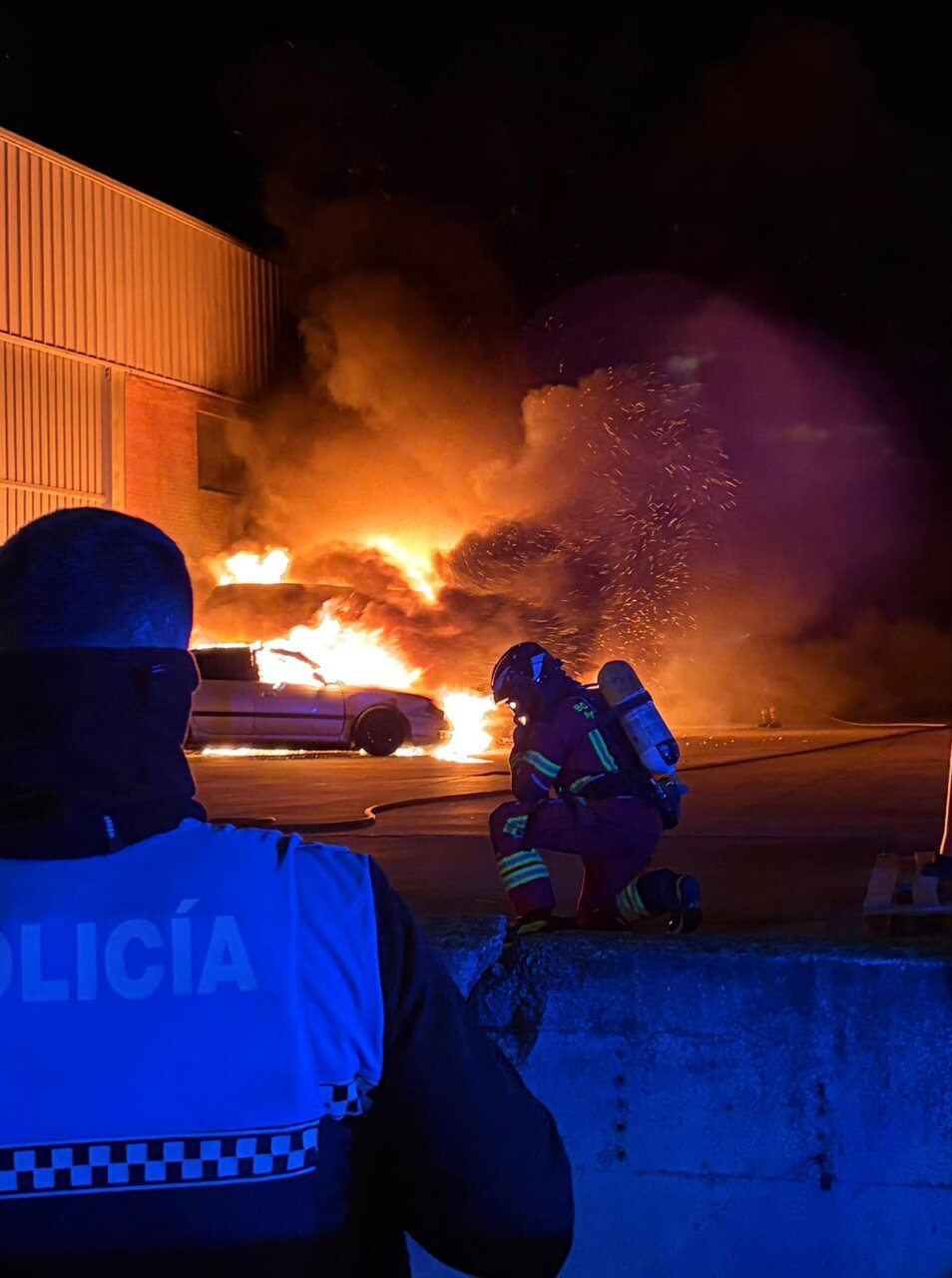 Bomberos extinguiendo un incendio en vehículos en la calle Sevilla