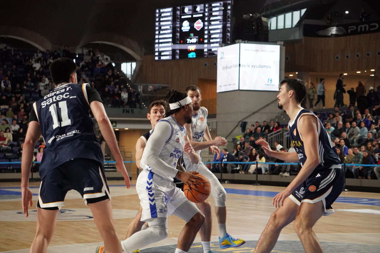 Jugadores de baloncesto en acción durante un partido entre Oviedo y Palencia.