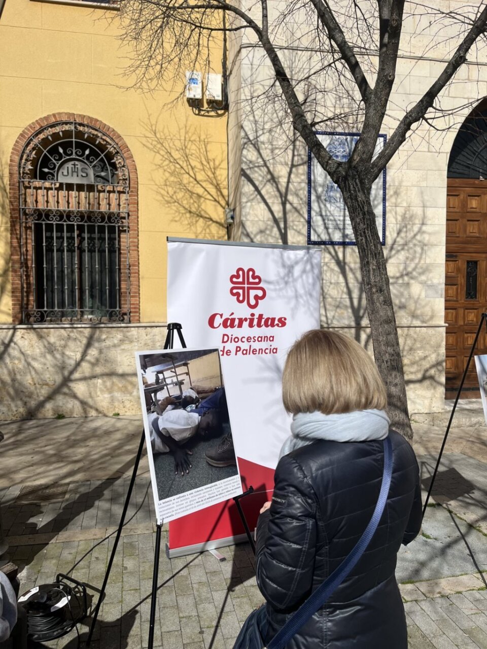 Persona observando una exposición sobre la crisis humanitaria en Sudán