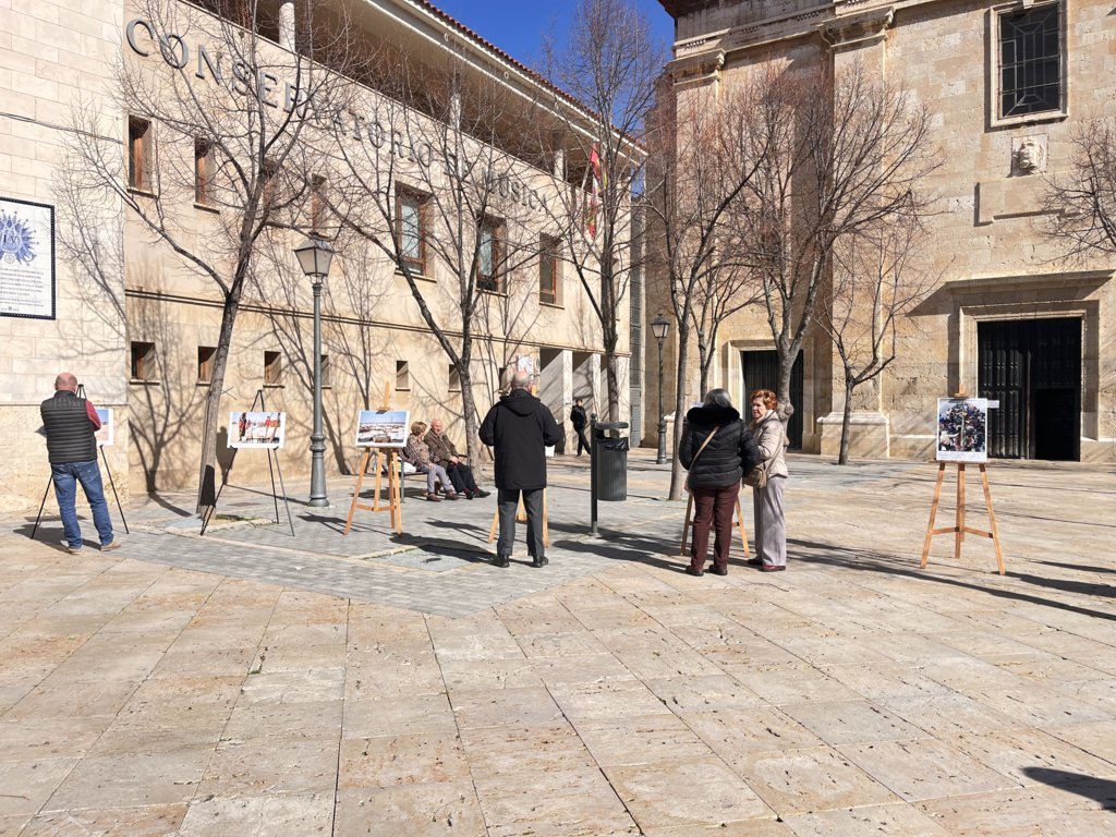 Personas observando una exposición fotográfica sobre la crisis en Sudán