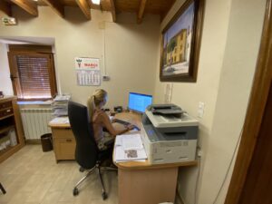 Mujer trabajando en un escritorio con ordenador y impresora