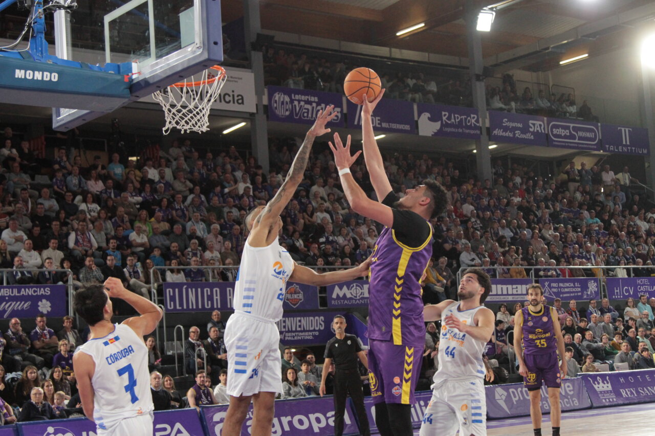 Jugadores de baloncesto en acción durante un partido entre Palencia y Melilla.