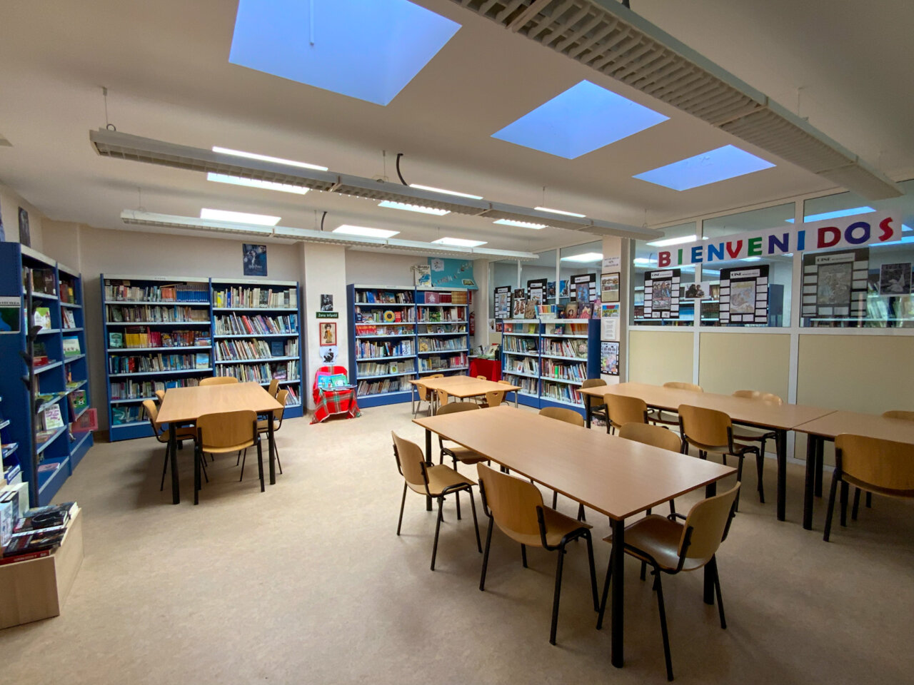 Interior de una biblioteca con estanterías y mesas de lectura