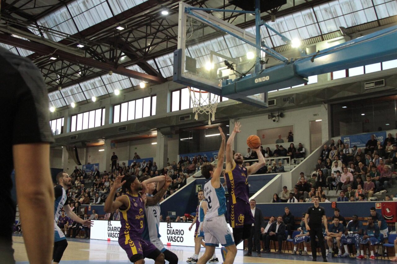 Jugador de baloncesto lanzando a canasta en un partido