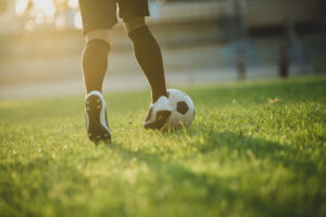 Jugador de fútbol en acción con balón en el campo