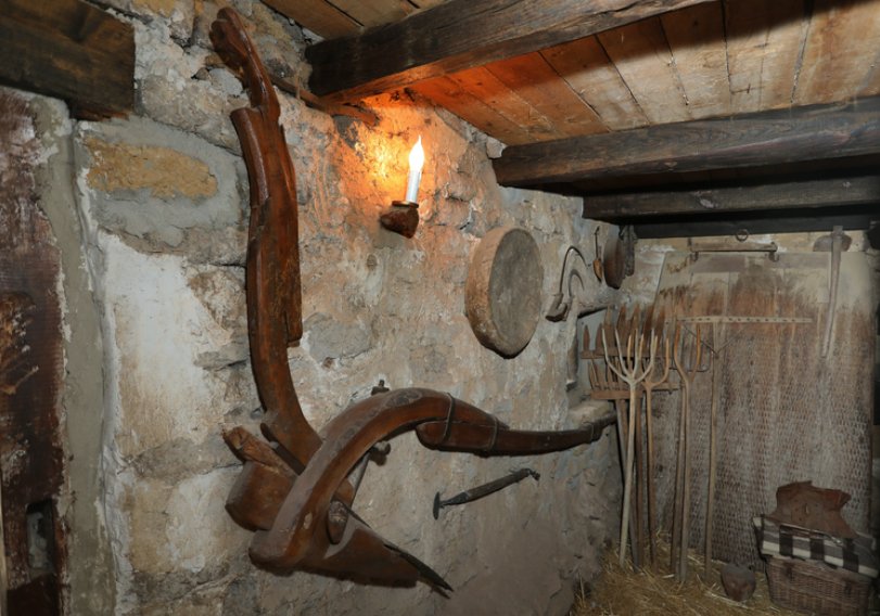 Interior de La Casa del Abuelo con herramientas antiguas y decoración rústica