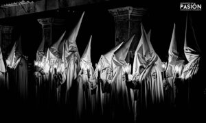 Fotografía en blanco y negro de cofrades en Semana Santa