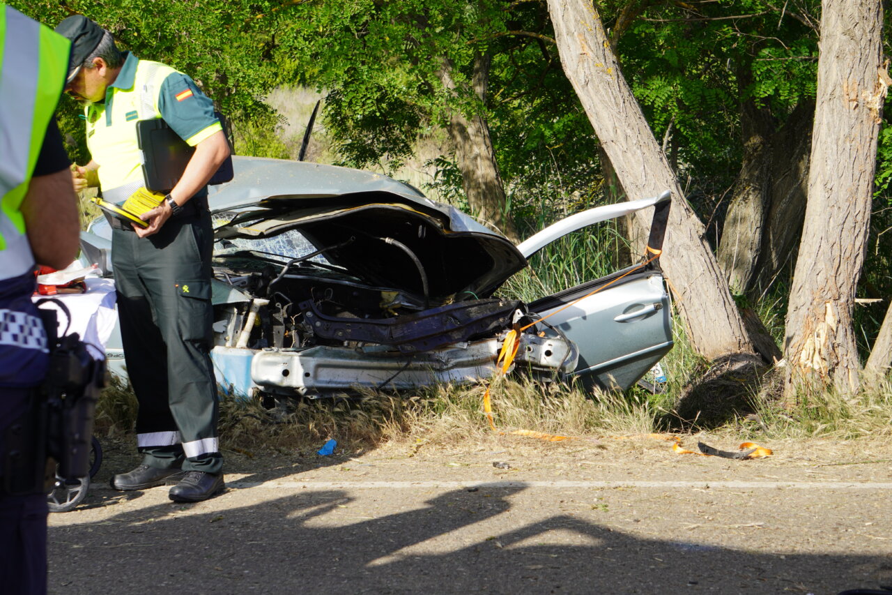 Vehículo accidentado en la carretera Palencia-Villamuriel con bomberos presentes.