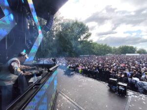 DJ actuando en una fiesta universitaria con gran multitud de jóvenes