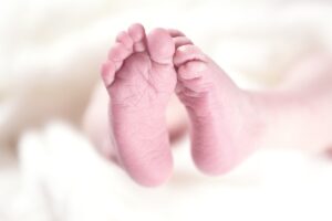 Pies de un bebé recién nacido sobre una superficie suave