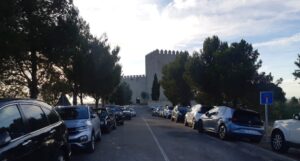 Vista del Castillo de Monzón con coches estacionados en primer plano