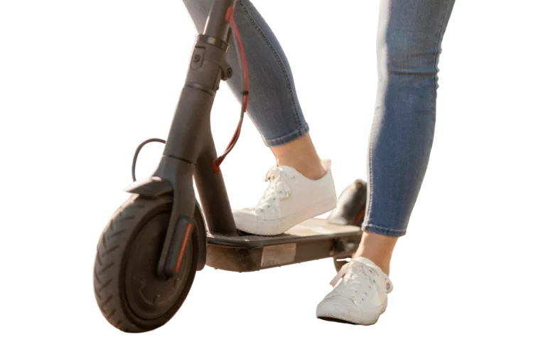 Mujer joven montando un scooter eléctrico en la ciudad