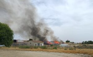 Incendio en el punto limpio de Grijota con humo y llamas visibles.