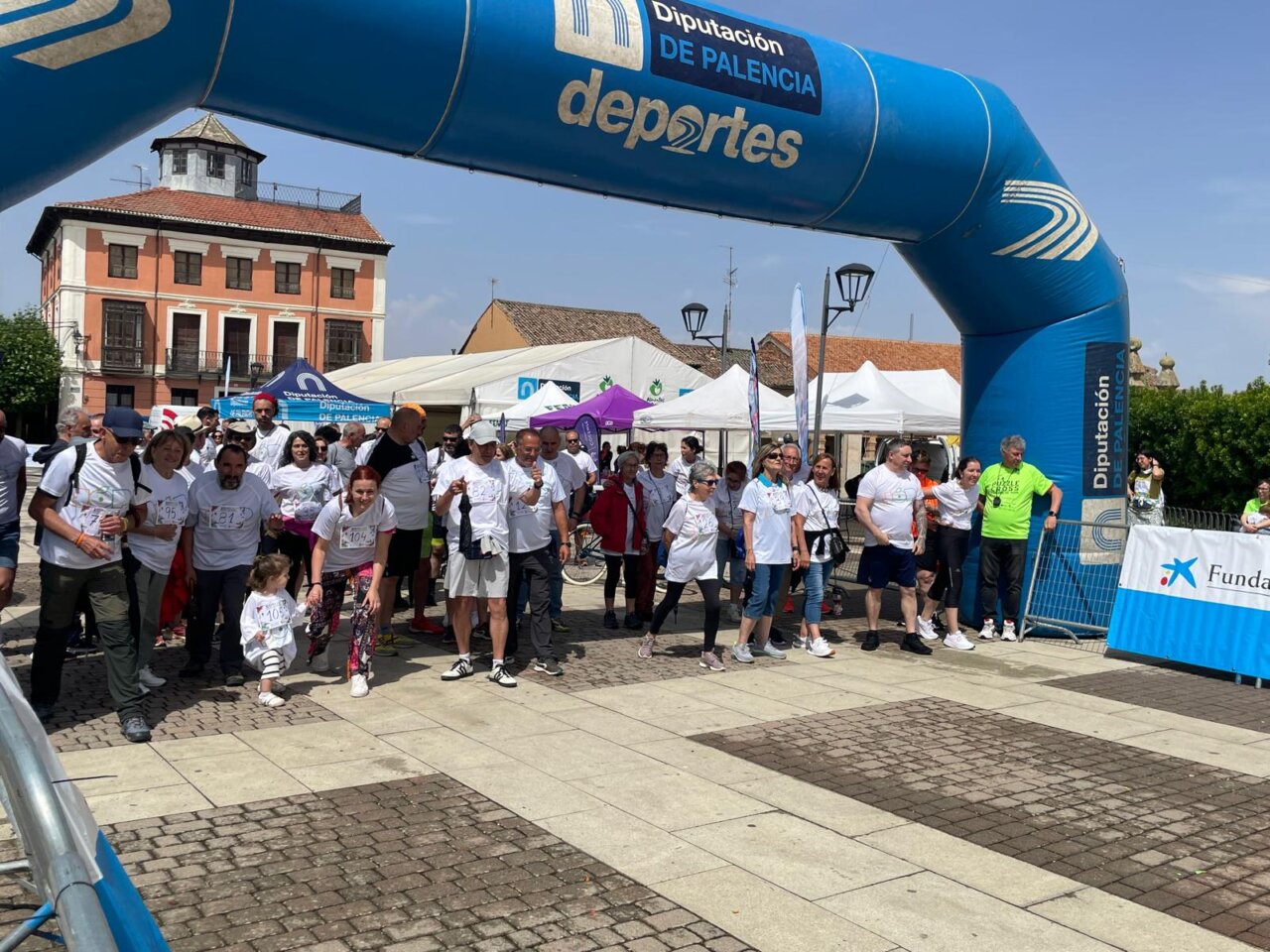 Participantes del XI Puzzle Cross en Paredes de Nava bajo un arco de meta