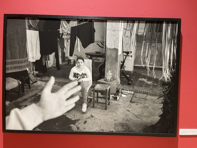 Fotografía en blanco y negro de una niña sentada en un entorno rural.