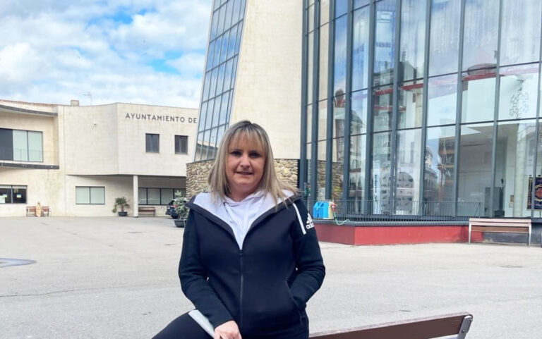 Mujer sonriendo frente al Ayuntamiento de Guardo
