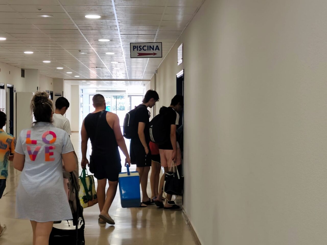 Grupo de personas dirigiéndose a la piscina del Campo de la Juventud en Palencia.