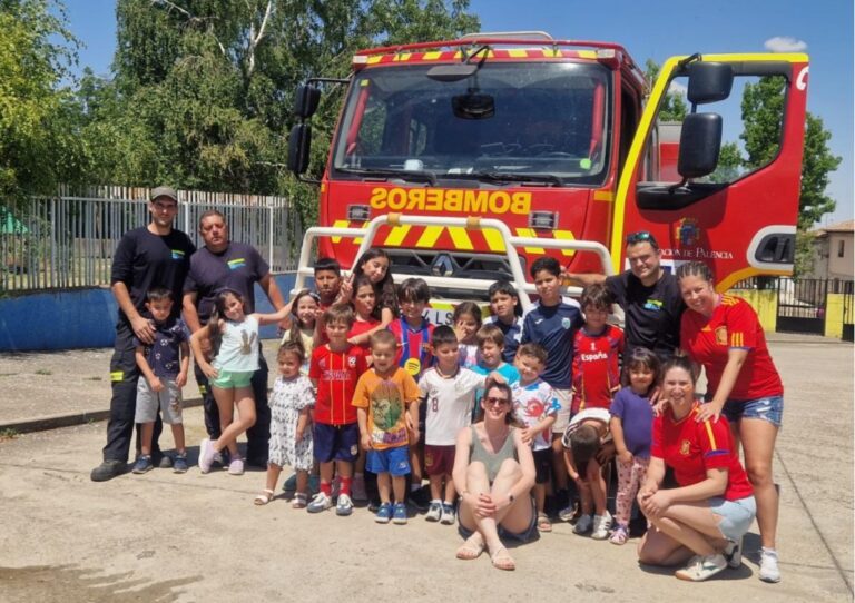 Grupo de niños y bomberos durante una visita educativa en Ampudia