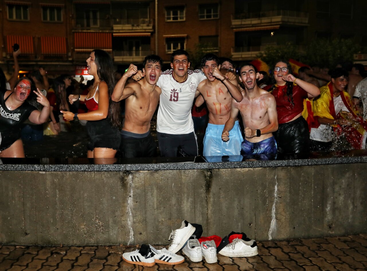 Jóvenes celebrando en la fuente de la Plaza España tras el Mundial