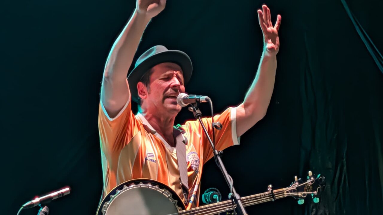 Músico actuando en el PipaFest de Villada con banjo y gestos expresivos