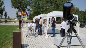 Personas observando un eclipse solar con telescopios en La Olmeda
