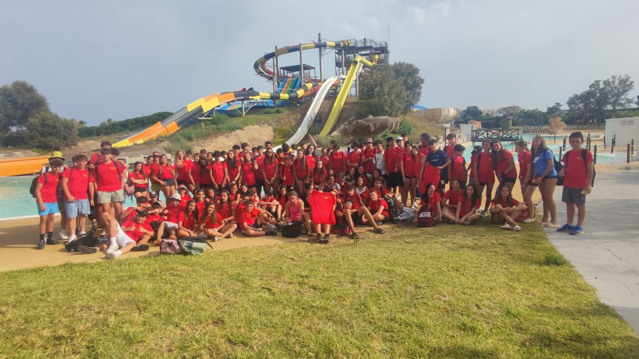 Grupo de jóvenes en un parque acuático con toboganes de colores