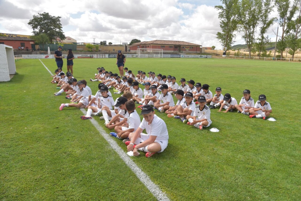 Niños sentados en el campo durante el campus de la Fundación Real Madrid
