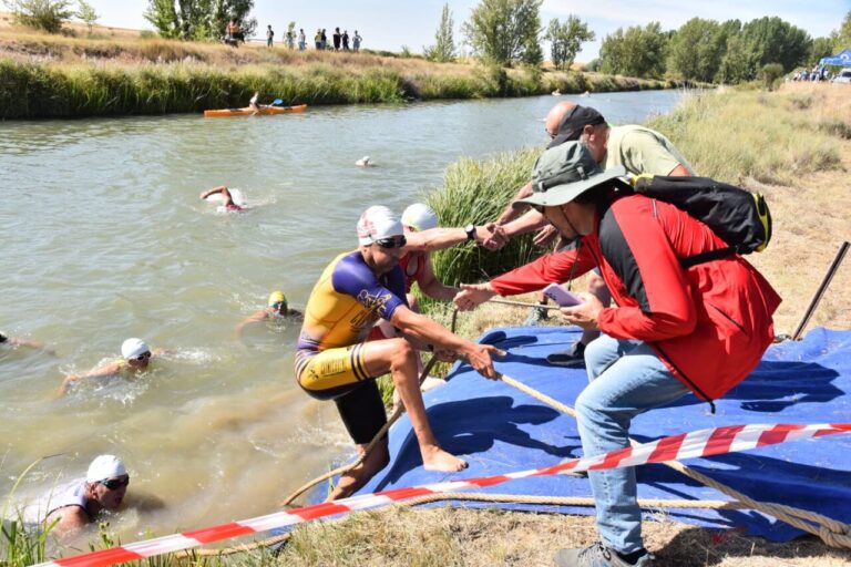 Triatletas en el agua durante el III Triatlón Cross en Boadilla del Camino