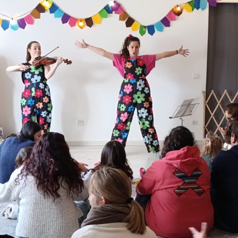 Actuación de dos artistas en un espectáculo familiar con música y humor.