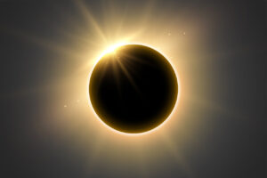 Eclipse solar total con destellos de luz alrededor del sol