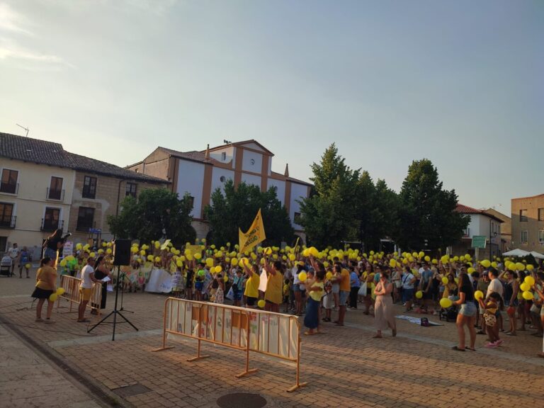 Concentración en Dueñas con globos amarillos para exigir un nuevo colegio
