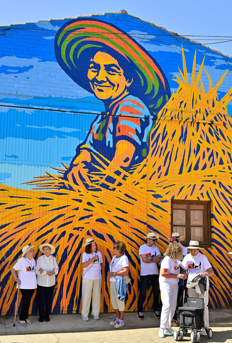 Mural colorido de una mujer con sombrero en Polvorosa de la Valdavia.