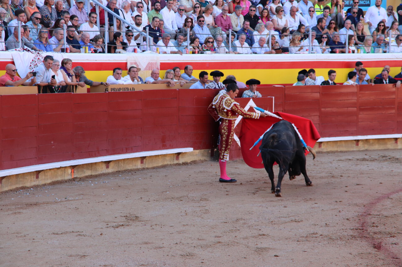 Torero realizando un pase con la capa en la plaza de toros de Palencia.