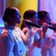 Las Tanxugueiras cantando en un escenario durante La Revuelta.