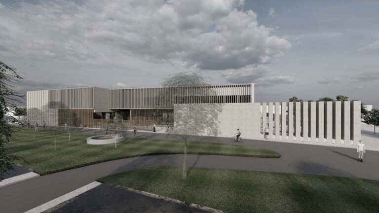 Render arquitectónico de un colegio moderno con fachada geométrica y zonas ajardinadas.